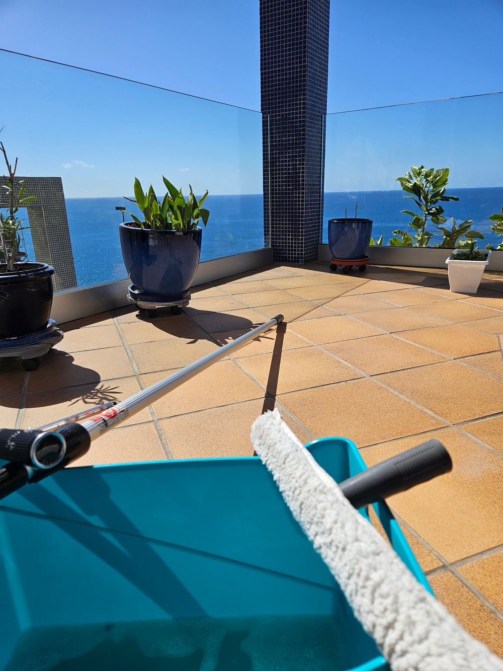 Terraza con vistas al mar y equipo de limpieza de cristales